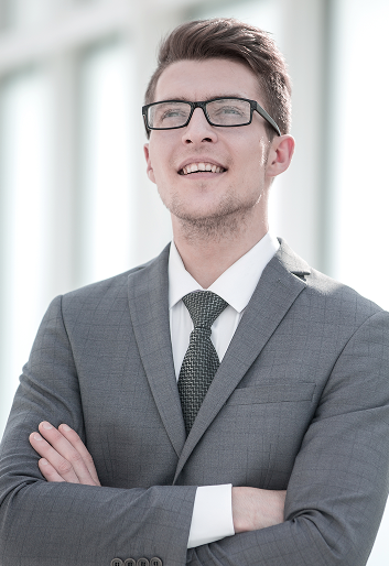 confident-successful-young-businessman-standing-office 1-1