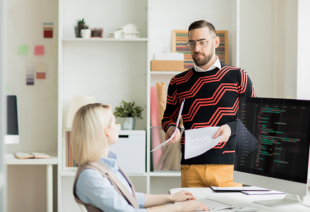 manager-giving-paper-with-task-coding-specialist 2