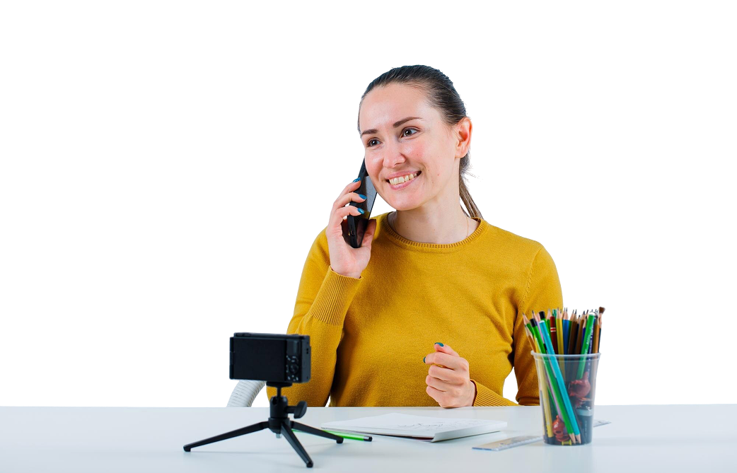 smiling-blogger-girl-is-looking-away-by-talking-mobile-white-background 1